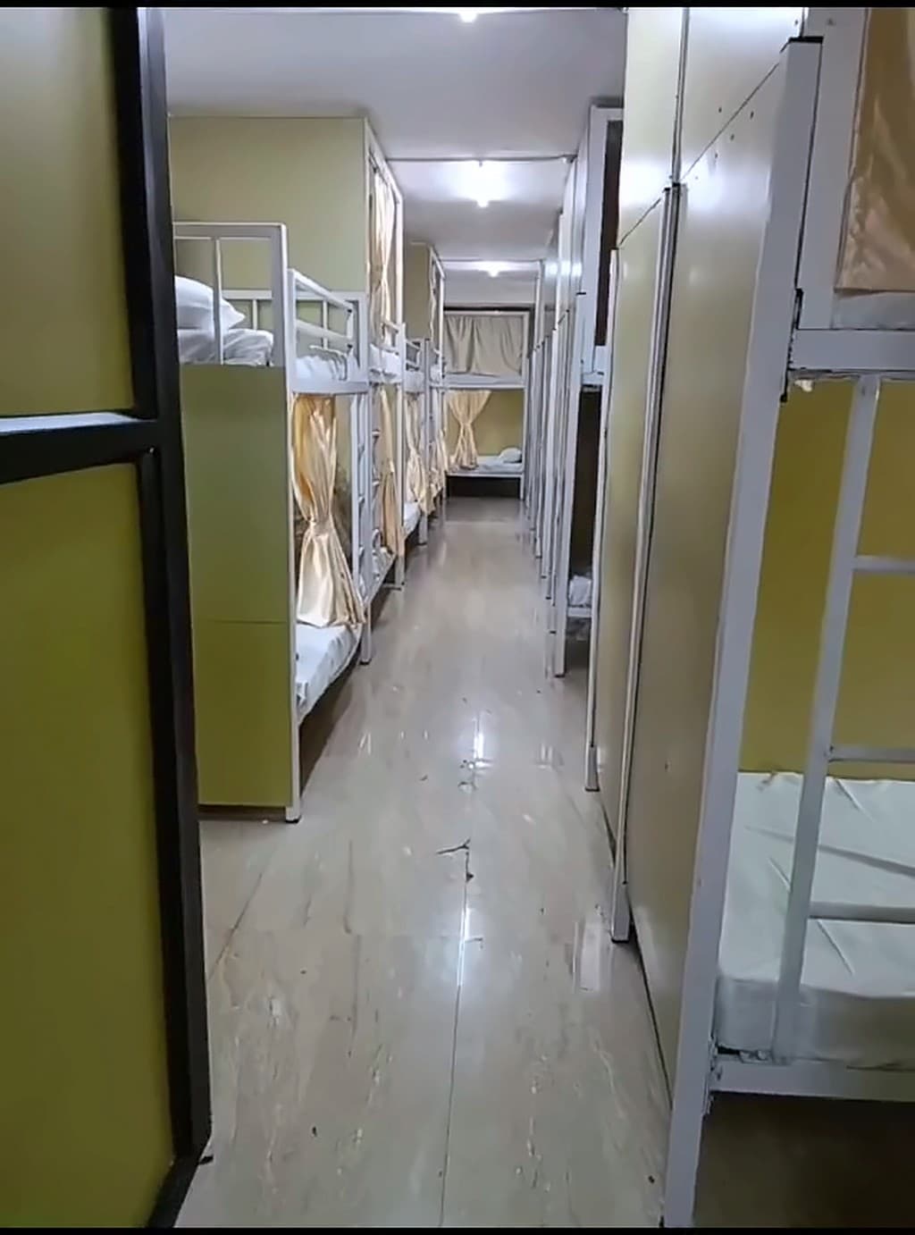 Aisle between rows of bunks in the AC dormitory