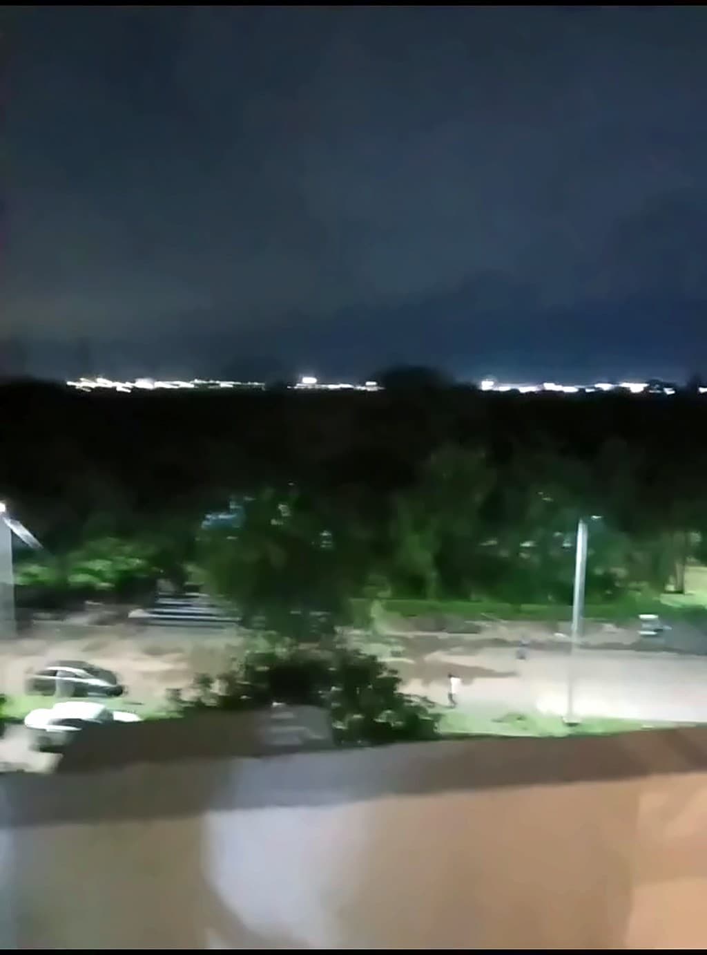 Night view over the trees and city lights from the SNOOZ window